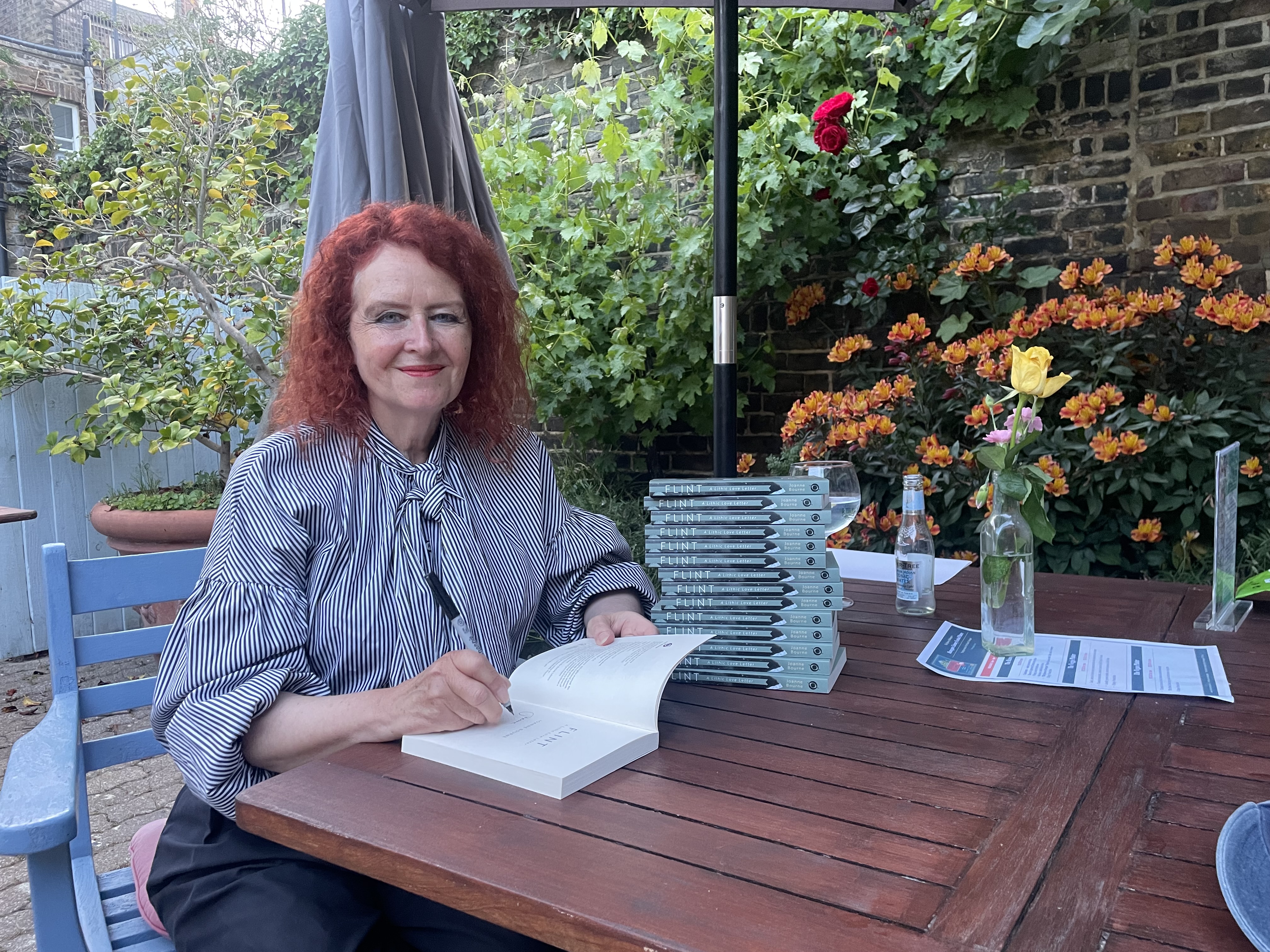 Joanne Bourne signing books in the garden