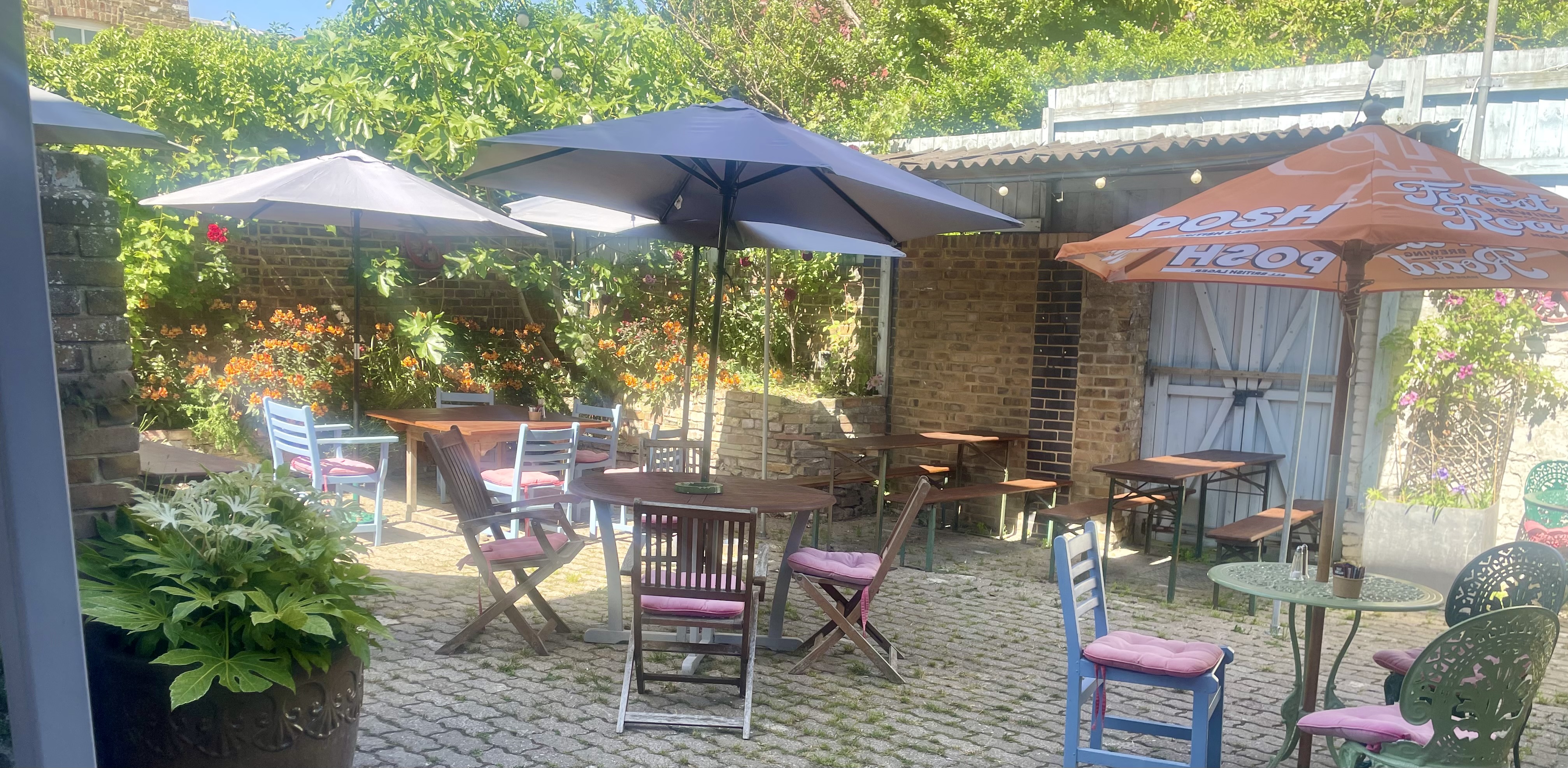 The secret garden at The Book Hotel — outdoor dining with flowers